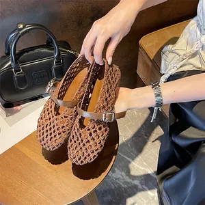 Close-up detail showing the intricate texture of brown hand-woven hollow-out Mary Jane flat shoes