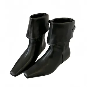 Elegant black leather boots featuring a square toe and versatile foldable ankle cuff.