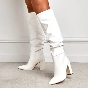 Elegant white pointy toe slouchy boots with chunky high heels for fashionable women