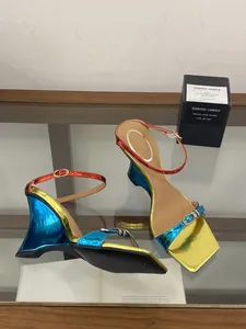 Detailed view of metallic gradient wedge heels with contrast blue and gold finish