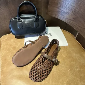 Close-up detail of hand-woven brown Mary Jane flat shoes with adjustable buckle strap
