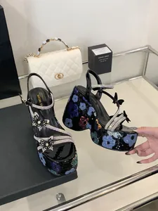 Close-up of chunky platform sandals with colorful floral sequins and rhinestone straps