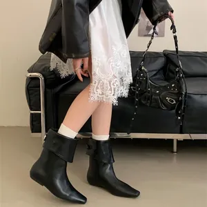 Stylish black fold-over Chelsea ankle boots for women with a chic leather finish