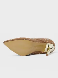 Detailed close-up showing the gold stiletto heel and sole of a brown rhinestone boot