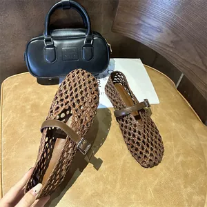 Detail view of brown hand-woven hollow Mary Jane flats with buckle strap