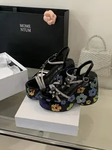 Detail view of floral sequin platform sandals with rhinestone flower straps