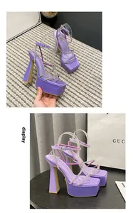 Close-up view of purple platform sandals with sparkling rhinestone straps and chunky heels.