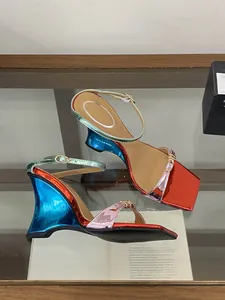 Detailed view of metallic gradient wedge sandals featuring a colorful sculptural heel