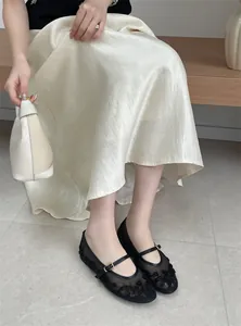 Elegant black mesh flat shoes with floral embroidery and Mary Jane strap on a model