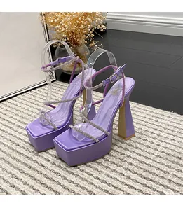 Detailed shot of purple platform sandals with rhinestone straps and chunky heels