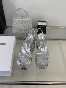 Detailed view of silver sequined wedge platform sandals with butterfly accents