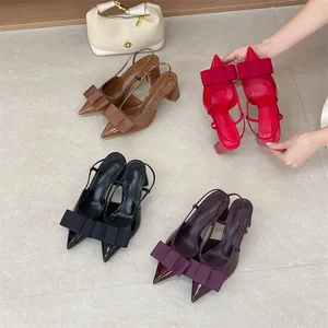 Detailed view of pointed-toe slingback heels with elegant bow decorations in multiple colors