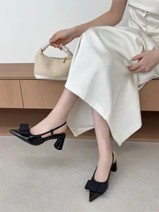 Elegant black patent leather slingback heels with bow detail and chunky heel for work