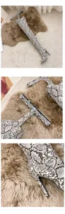 Close-up of snake print pointed-toe over-the-knee pant-boots with stiletto heel