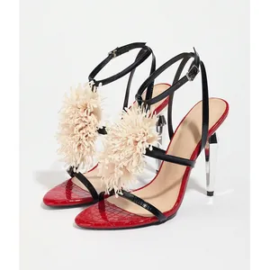 Detail of red crocodile texture sandals with chrome heel and beige flower ornament
