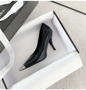 Elegant black patent stiletto with silver metal pointed toe cap, detailed view