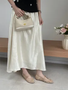 Close-up detail of beige mesh flat shoes with elegant floral embroidery and strap