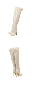 Detailed view of cream-colored cracked pattern thigh-high boots with pointed toe