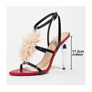 Red and black high heel sandals with beige floral ornament and transparent faceted heel