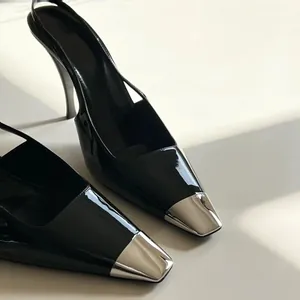 Elegant black patent leather slingback high heels with metallic silver pointed toes.