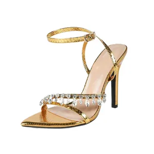 Elegant gold snakeskin stiletto sandals with crystal fringe and ankle strap