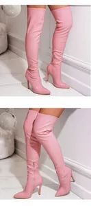 Close-up detail of stylish pink crackle-patterned thigh-high boots with pointed stiletto heel