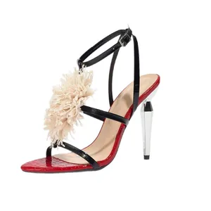 Elegant red and black high heel sandals with large cream flower and faceted heel