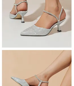 Detail view of elegant silver glitter pointed-toe slingback heels with kitten heels.