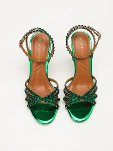 Detailed top view of emerald green metallic high-heel sandals with dark rhinestone straps