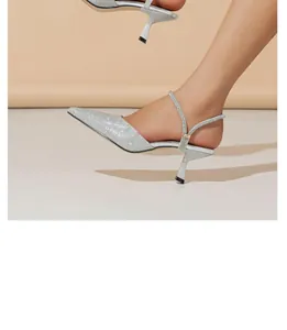 Side view of elegant silver glitter pointed-toe kitten heel slingback pumps for women