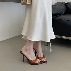 Detailed view of brown transparent PVC strap high-heeled mules with pointed toe