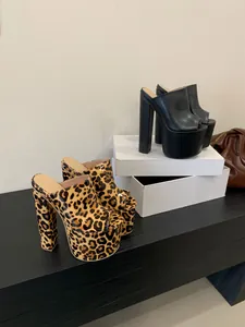 High-fashion peep-toe platform mules with chunky high heels in leopard and black.