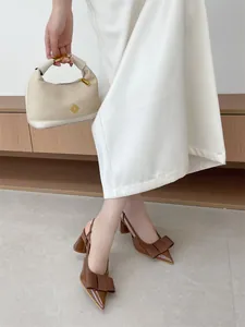 Elegant brown pointed-toe slingback pumps with bow detail and block heel for women