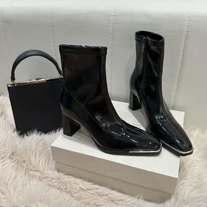 Elegant black patent leather ankle boots with thick block heel and square toe detail