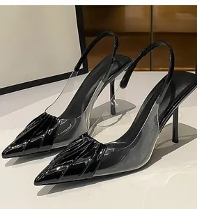 Elegant detail of black pointed toe slingback heels with pleated patent leather toe