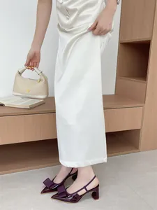 Detail view of purple patent leather chunky heel sandals with decorative bow knot
