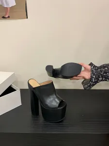 Chic black platform chunky heel mules with open toe design showing outsole details