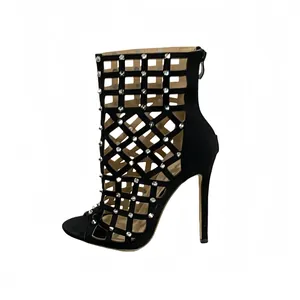 Detailed side view of black stiletto ankle boots with hollow-out cage and rivets