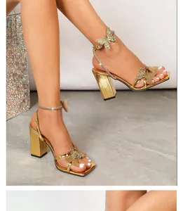 Side view of gold sandals with glittering butterfly motifs and rhinestone ankle straps