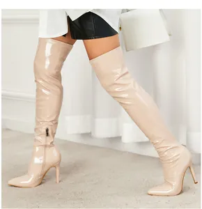Stiletto over-the-knee boots in nude patent leather with a sleek pointed toe