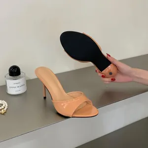 Detailed view showing the side profile and sole of the peach stiletto mule sandals.