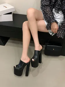 Black peep-toe platform mules with high chunky heels shown in a lifestyle setting