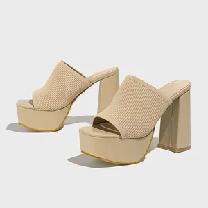 Detail view of beige knitted platform mules with thick high heels and square toe