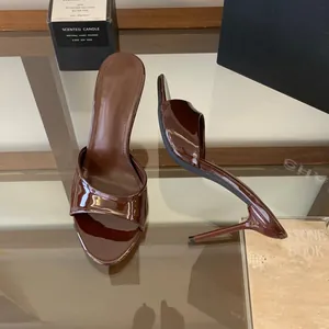 Detailed view of brown patent leather high-heeled mules with 9cm stiletto heel