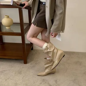 Stylish beige pointed-toe slouchy wedge boots with a modern folded design for women's fashion