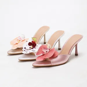 Elegant satin high heel mules with large orchid flower decoration in three colors.