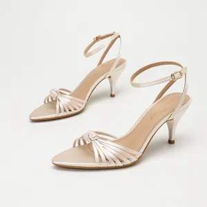 Elegant champagne satin sandals featuring crisscross straps and kitten heels for women