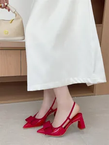 Elegant red pointed-toe slingback pumps with a decorative bow and comfortable block heel