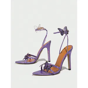 Purple stiletto sandals featuring 3D butterfly details and a sleek pointed toe design.
