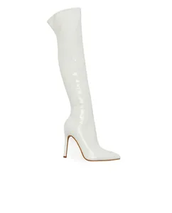 Detailed side view of white patent leather over-the-knee boots with stiletto heel.